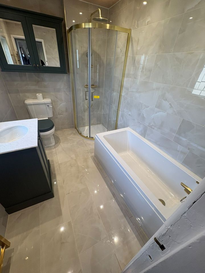 Bathroom with gold shower enclosure and green vanity